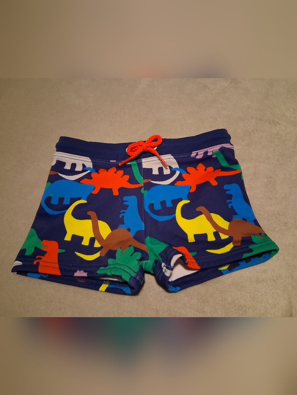 Baby Boden Navy Dino Print Swim Shorts with Orange Drawstring